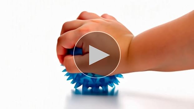 Close-up of a spiky sensory ball being held in a hand