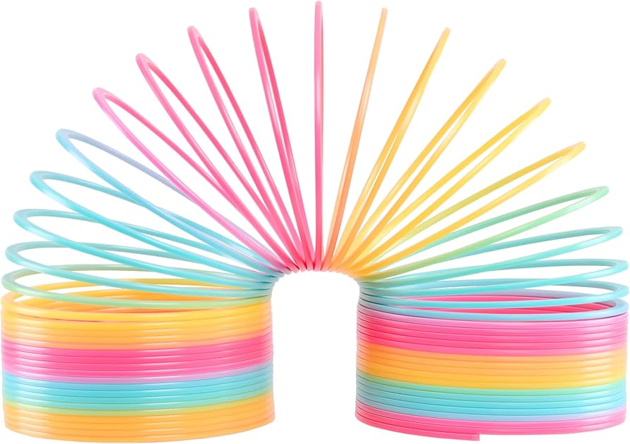 A metal Slinky and a colorful Boink fidget toy on a table