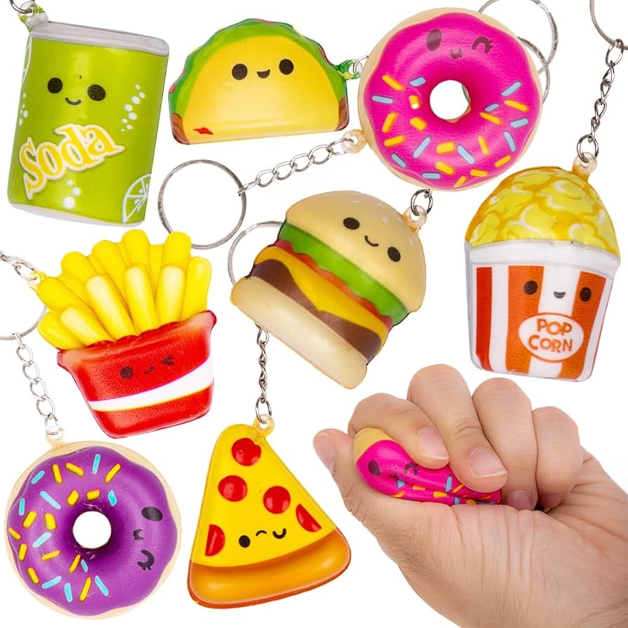 Assorted slow-rise squeeze toys shaped like peach, burger, and animals on a desk