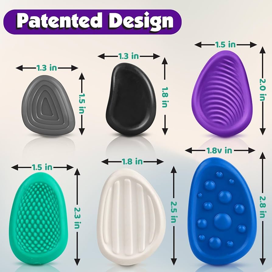 Assortment of tactile fidget toys including a fidget cube, textured stones, and putty