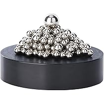 A collection of magnetic balls formed into a geometric shape on a metal surface