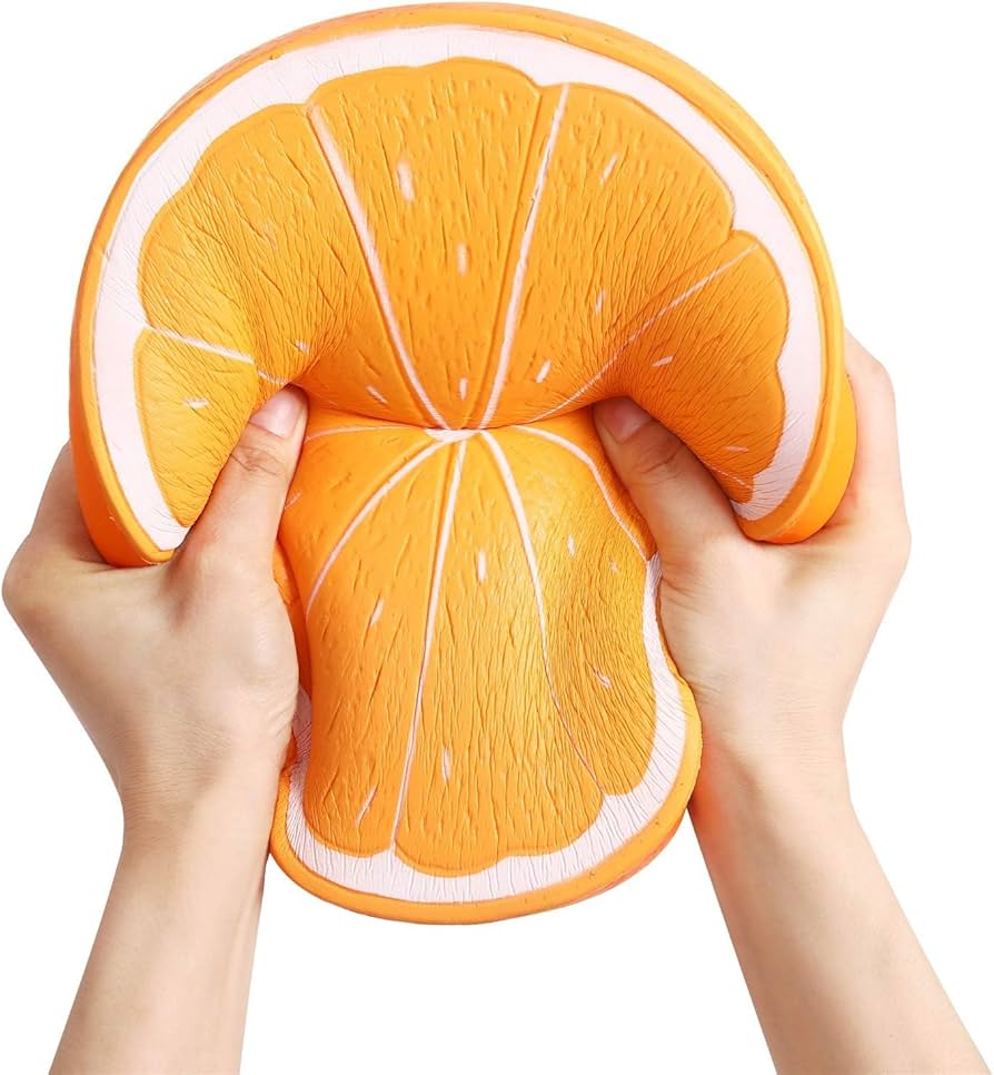 A hand squeezing a soft, orange slow-rise foam toy