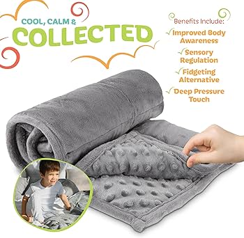 A grey weighted blanket neatly folded on a cozy armchair