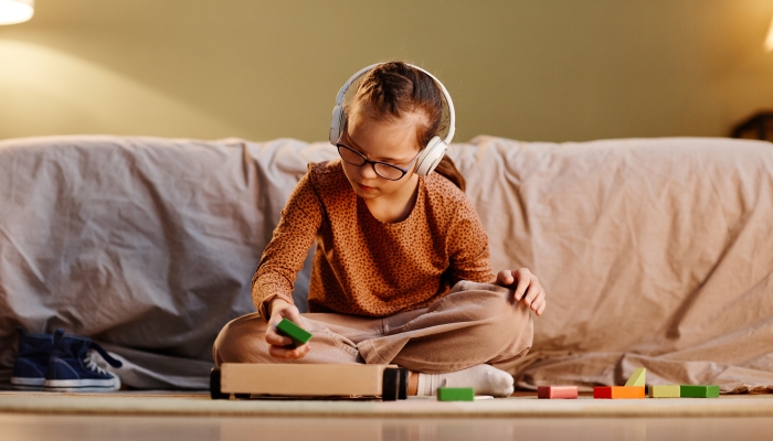 A person wearing noise-canceling headphones sitting calmly in a busy cafe