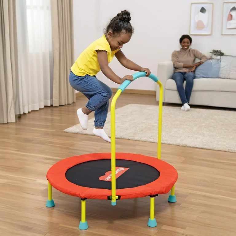 A 5-year-old boy jumping happily on a mini indoor trampoline