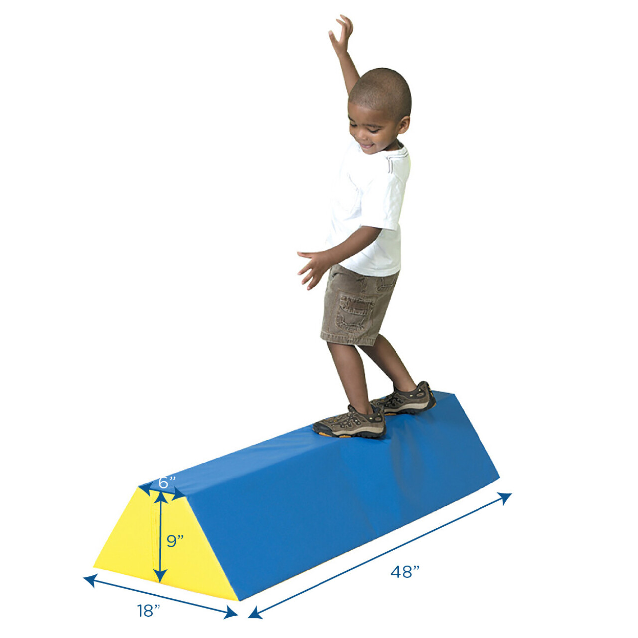 A child balancing on a low indoor balance beam with soft mats around
