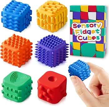 Close-up of a fidget cube and pop-it toy with different textures and buttons
