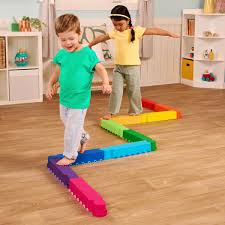 Low-to-the-ground, interlocking rainbow-colored balance beams for toddlers
