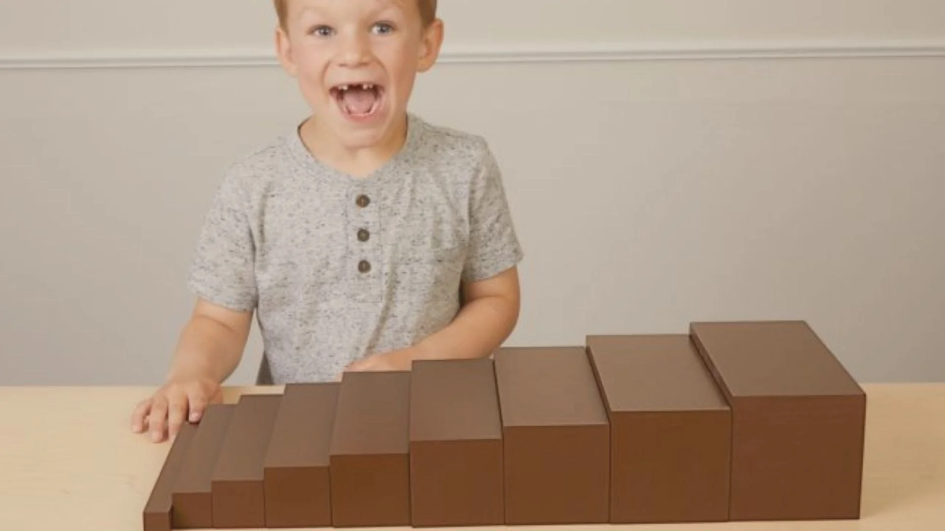 Child stacking Montessori brown stair wooden blocks