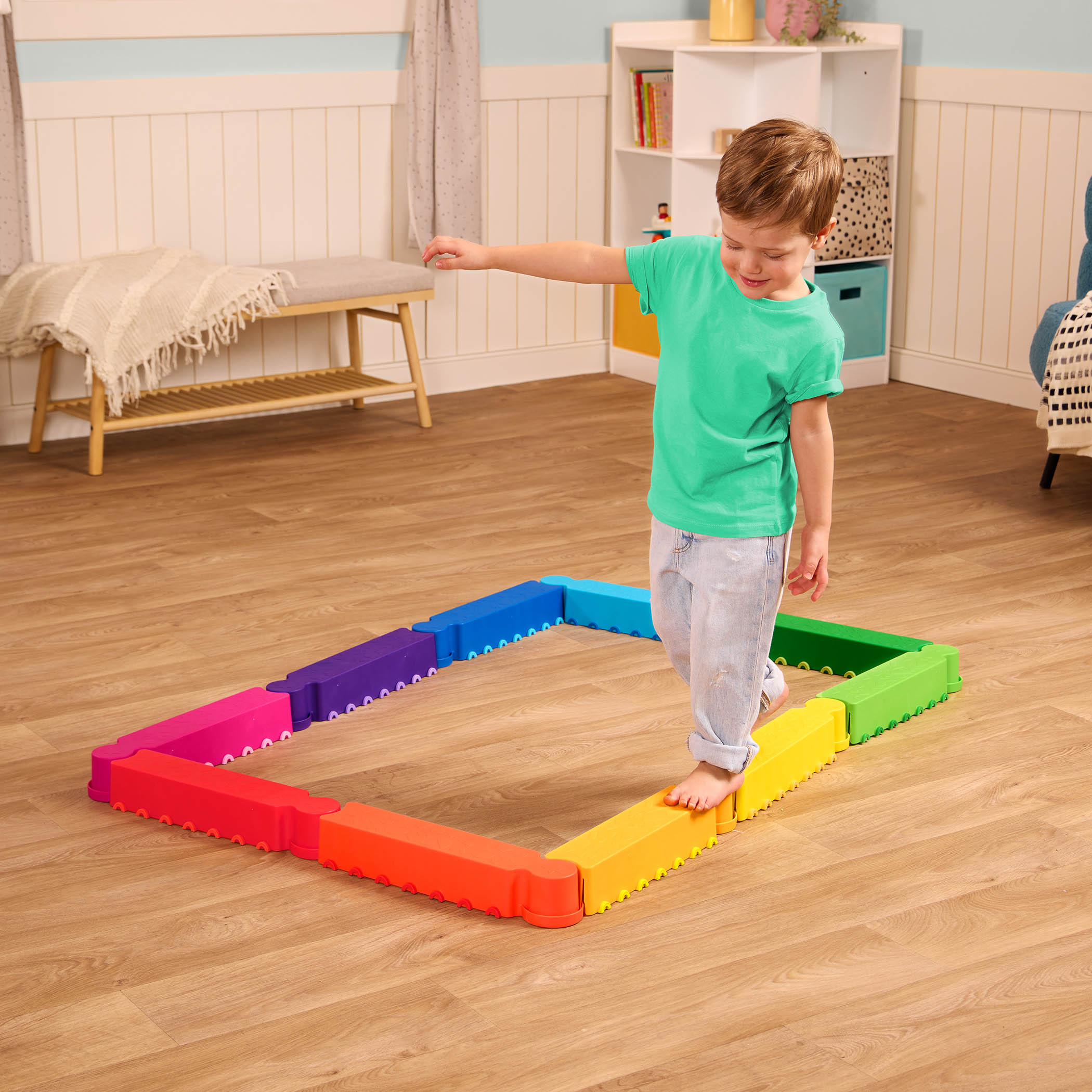 Child walking on colorful foldable balance beam